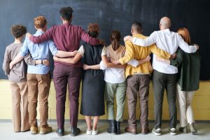 People-in-line-with-hands-around-shoulders