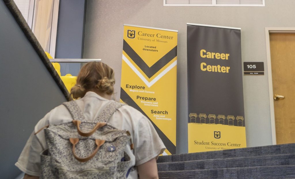 student-walking-by-Career Center-banners