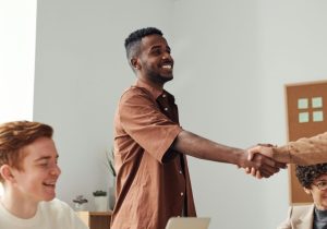 Man-smiling-shaking-hands