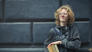 smiling-college-student-holding-books