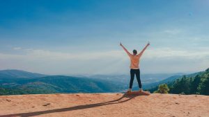 Summit-hiker-hands-outstretched