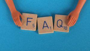 Hands-Holding-F-A-Q-letter-tiles