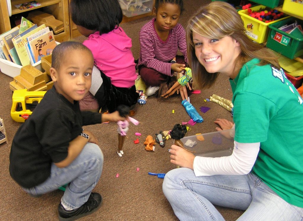 Mizzou PALS tutor playing on floor with child