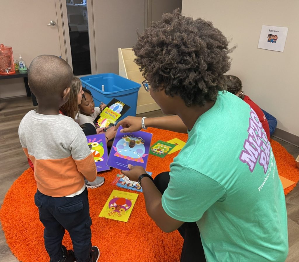 Mizzou PALS tutor playing with toys