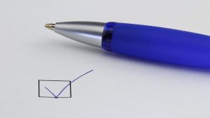 blue pen next to checklist