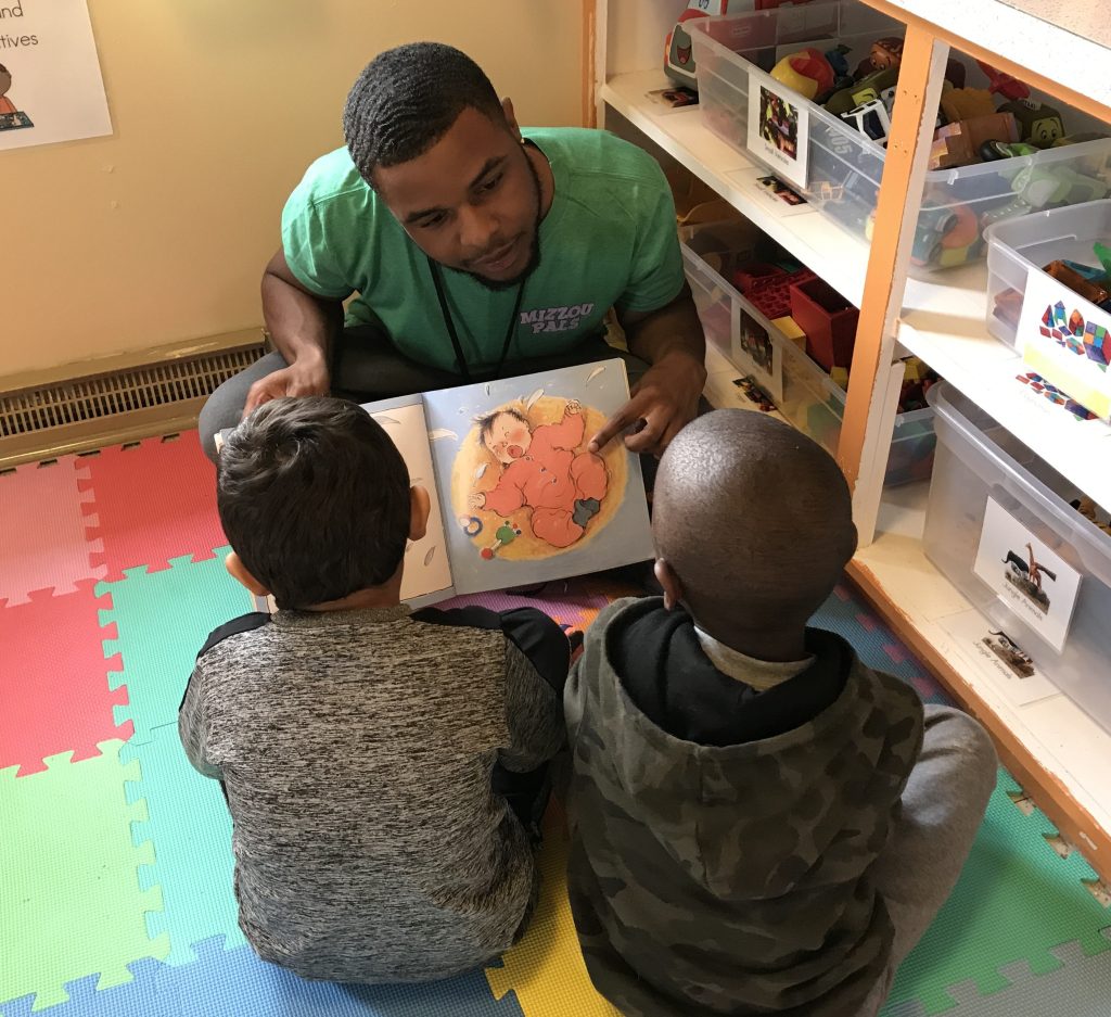 Mizzou-PALS-tutor-reading-book-to-two-preschoolers