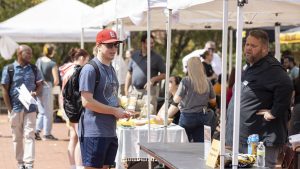 Student-speaking-with-campus-employer-at-job-fair
