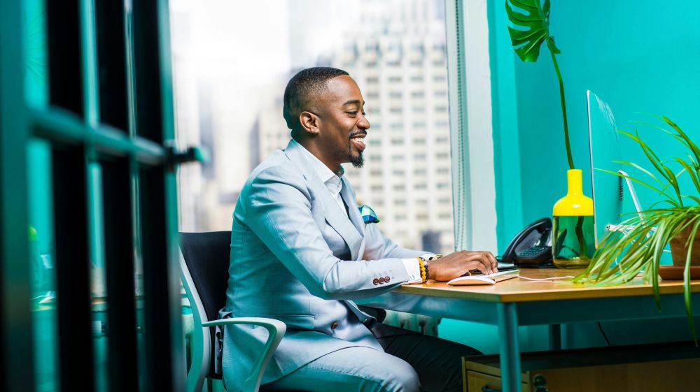 man-smiling-at-laptop