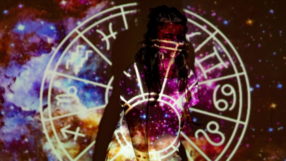 Zodiac image projected on woman