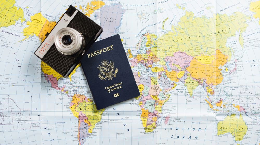 Passport-and-map-resting-on-map-of-world