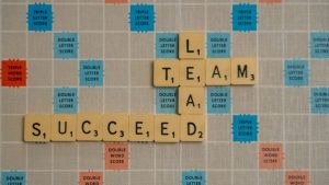scrabble letters spelling lead and success