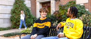 2 MU students talking on bench